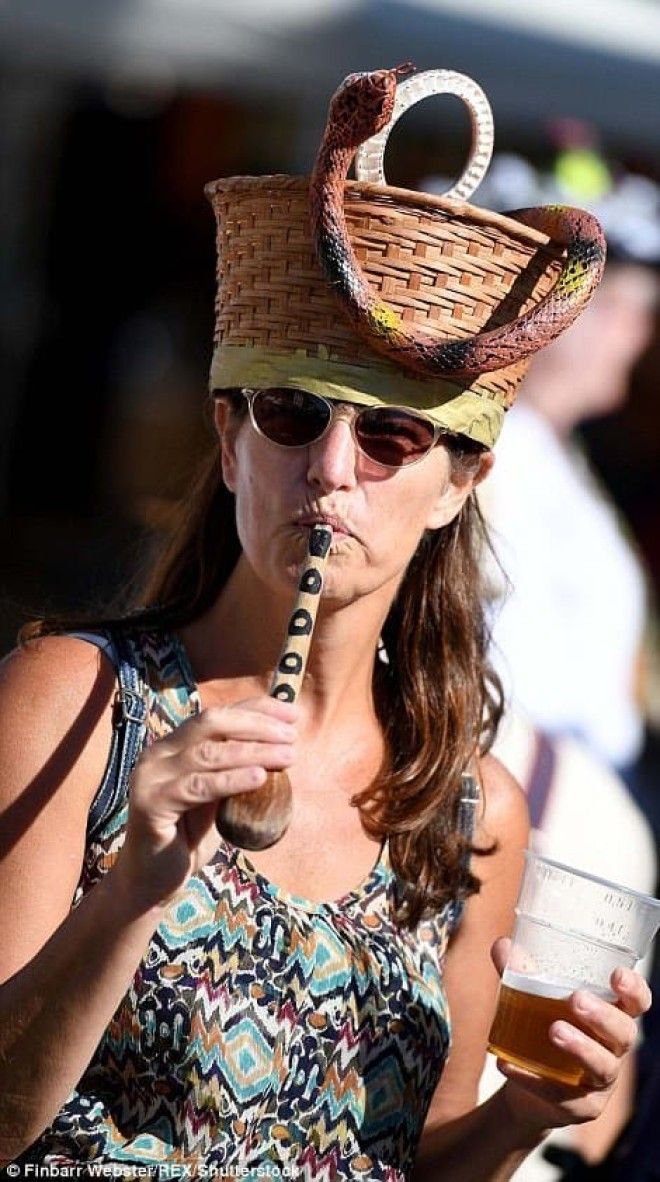 This woman appears to be summoning a snake from a basket with a wooden spoon