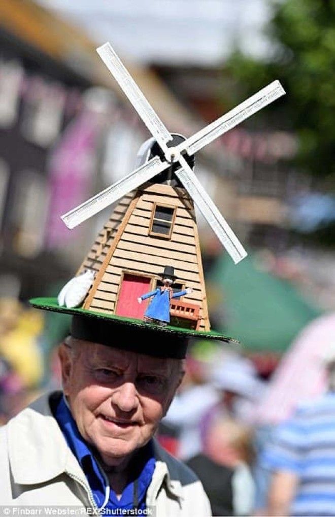 Windmill owner Windy Miller sits atop of this man