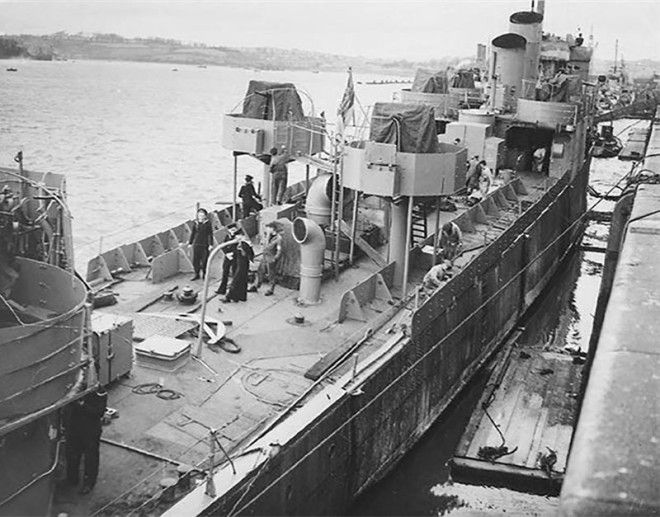 HMS Campbeltown being converted for the raid. There are twin lines of armour plate down each side of the ship and the Oerlikon mountings. Two of her funnels have been removed, with the remaining two cut at an angle St Nazaire Raid