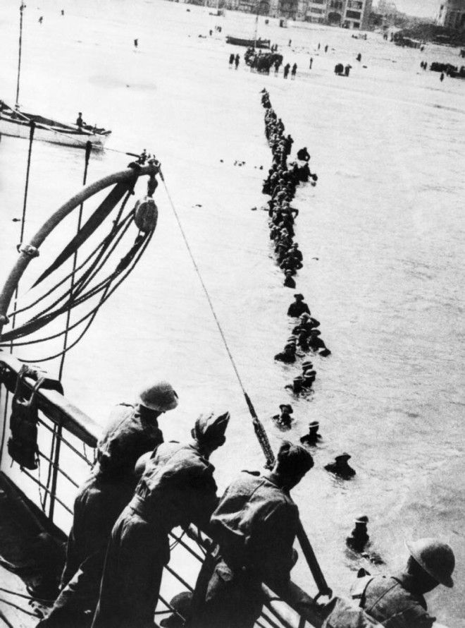 British soldiers wade out to a waiting destroyer off Dunkirk during Operation Dynamo